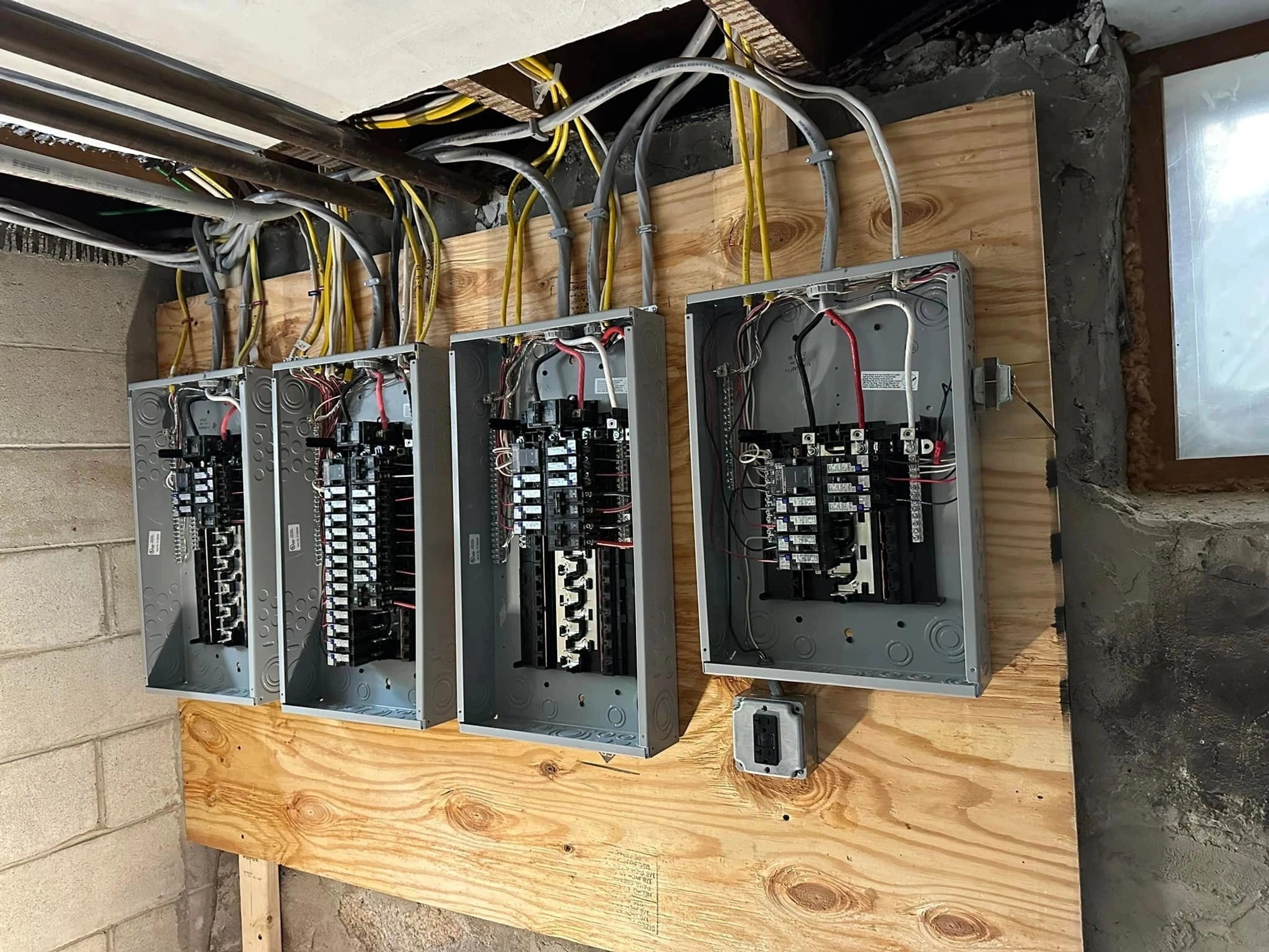 Bank of breaker panels and meter sockets installed by Pika Electrical